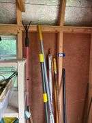 Corner lot: push broom, pick, rakes, lopper, shovel