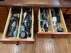 Contents of two drawers: utensils, measuring cups