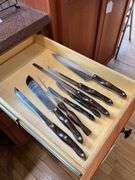 Contents of drawer: Cutco kitchen knives and carving fork