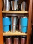 Contents of cupboard: travel mugs/tumblers