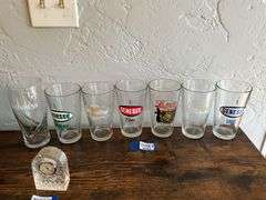 Seven advertising beer glasses