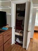 Contents of closet: drapery panels, hangers, throw pillows, comforters