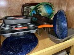 Contents of cupboard: Corningware casseroles, various baking pans, trays