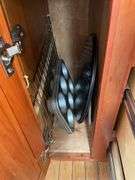 Contents of four drawers and one cupboard: coasters, baking pans, gadgets, hot pads, rolling pin, misc