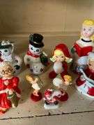 Contents of shelf: vintage china Santa and other Christmas figurines