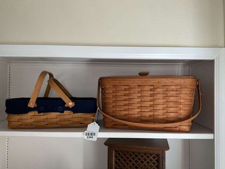 Two Longaberger baskets: one had cloth liner, other has hinged wooden lid