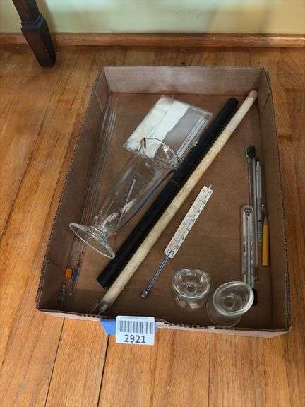 Glass eye wash cups, graduated beaker, thermometers