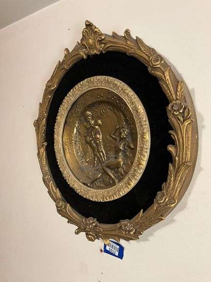 Cast metal plaque on black mount in gilt frame 19.5x21