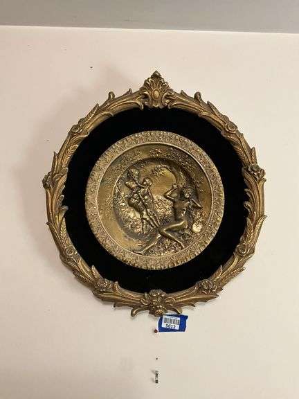 Cast metal plaque on black mount in gilt frame 19.5x21