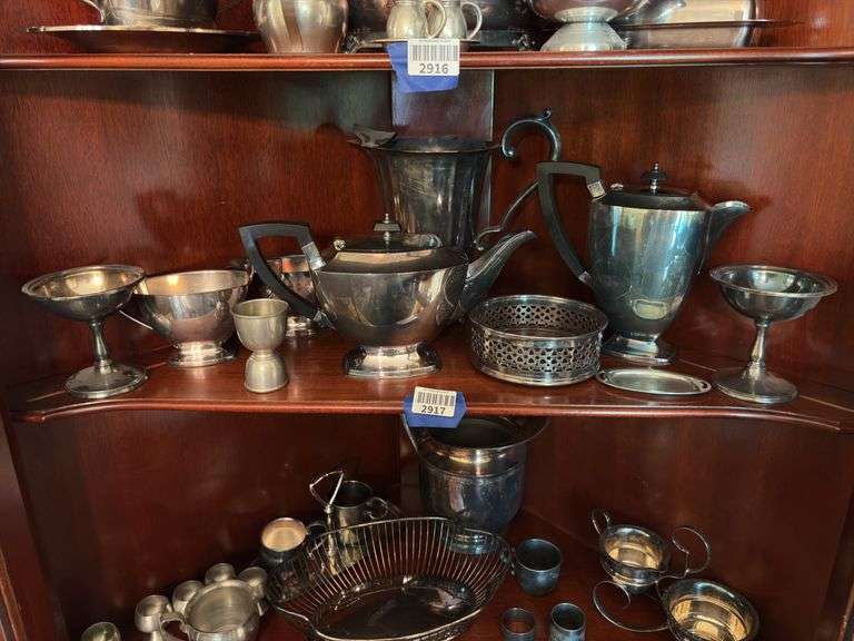 Contents of two shelves: silverplated tea and coffee pots, misc serving pcs