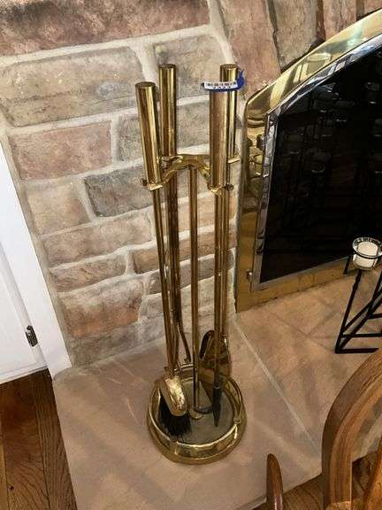Brass tone fireplace tools on rack