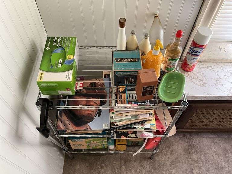Contents of bathroom: metal shelf unit w/ contents, linens, towel rack, ironing board, step ladder, household products, waste can, misc