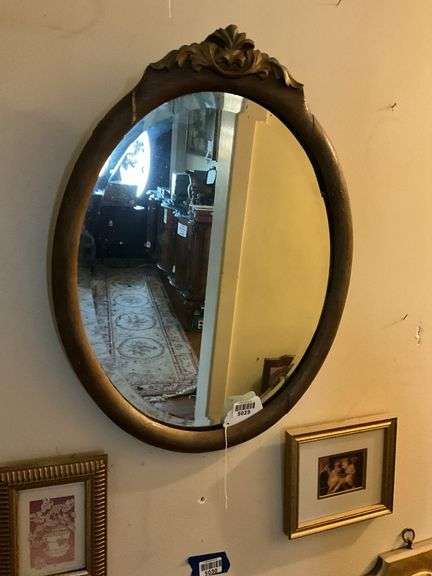 Oval beveled mirror in gilt frame w/ carved crest 18x24
