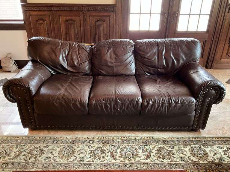 Brown leather sofa w/ decorative tack head trim - note tear in top rear 86x37x31