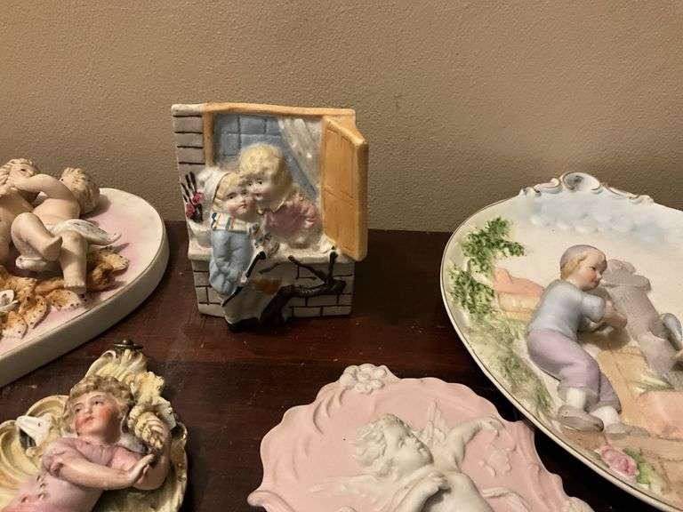 Collection of bisque plaques w/ cherubs and children in relief, and bisque match pocket