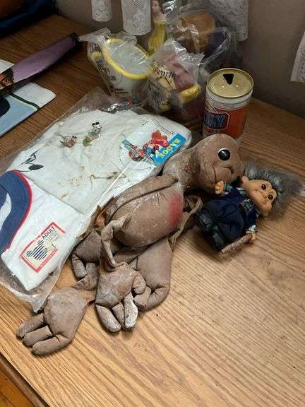 E.T. doll, Beauty and the Beast figures, troll doll, Mickey Mouse t-shirt, Billy beer can