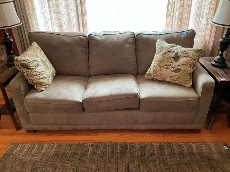 Upholstered sofa and two patterned throw pillows, 78in long