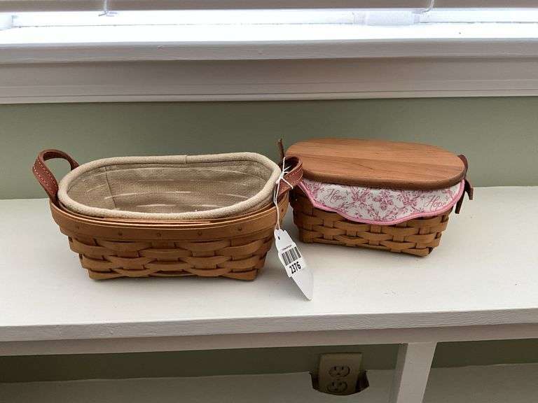 Two small Longaberger baskets, one has wooden lid