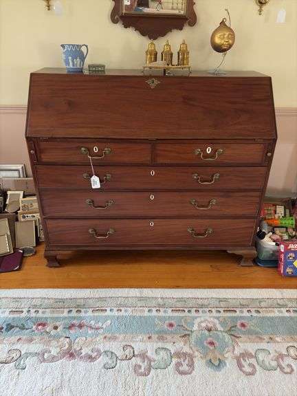 Slant front desk w/ compartmented interior w/ seashell inlaid prospect door, graduated drawers w/ inlaid escutcheons, ogee bracket feet  50x21x43