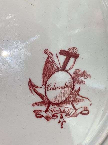 Contents of shelf: red Staffordshire transfer printed china including White Mountain NH scene and Columbus
