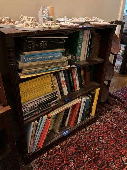 Book contents of three shelves: history, short stories, National Geographics, misc
