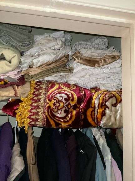 *In living room* Contents of closet: ladies jackets sz: lg/16, tablecloths and linens lot