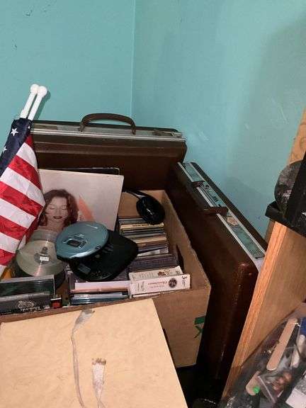 Corner desk and contents: desk accessoroies, CDs, brief cases, cables, misc