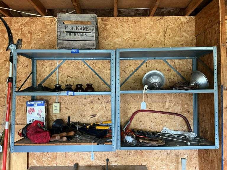 Contents of three shelves: fruit crate, insulators, clip-on lights, hand tools, hand vac, misc