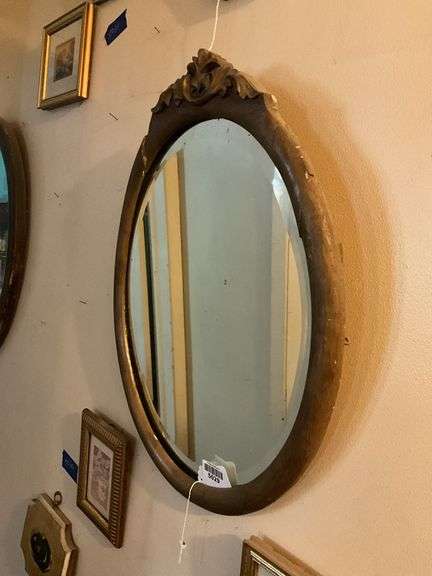 Oval beveled mirror in gilt frame w/ carved crest 18x24
