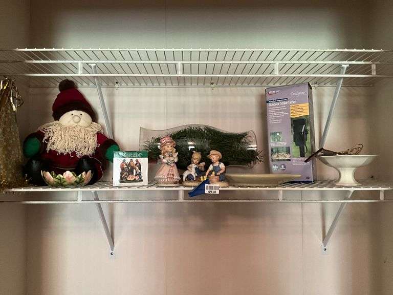 Contents of shelf: Santa doll, figurines, outdoor timer, misc