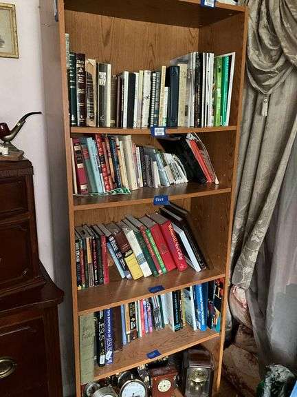 Book contents of four shelves: Bibles, golf, reference, misc