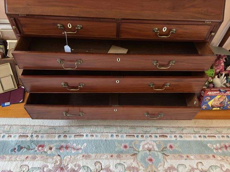 Slant front desk w/ compartmented interior w/ seashell inlaid prospect door, graduated drawers w/ inlaid escutcheons, ogee bracket feet  50x21x43