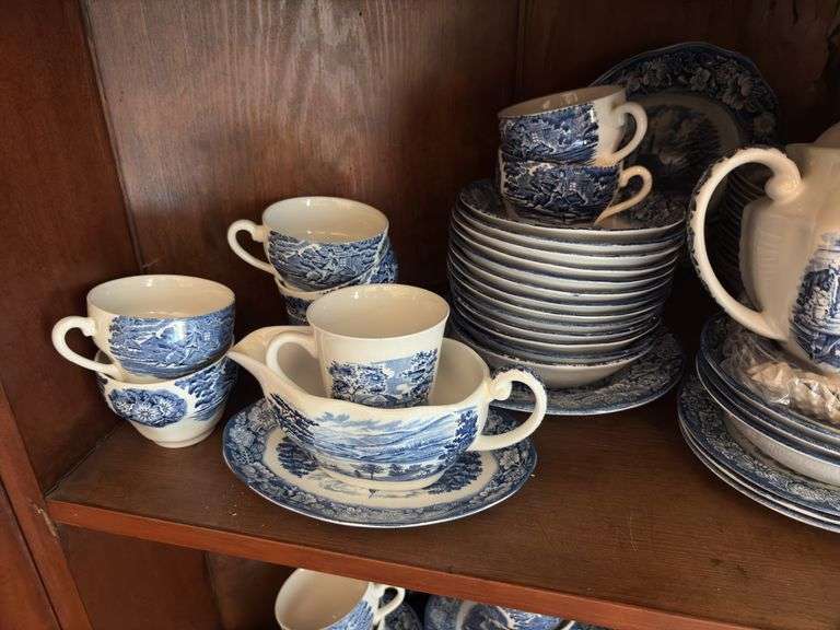Contents of two shelves: Liberty Blue Historic Colonial Scenes dinnerware set w/ serving pcs