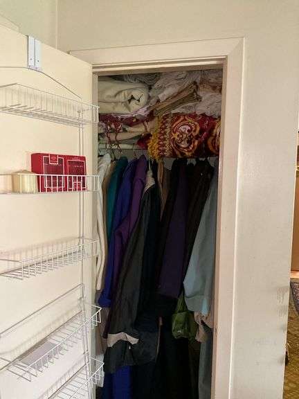 *In living room* Contents of closet: ladies jackets sz: lg/16, tablecloths and linens lot