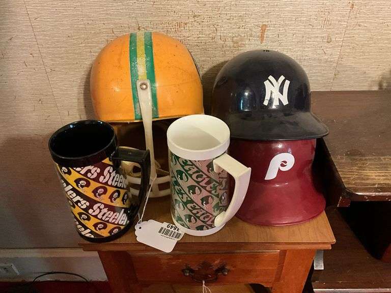Pittsburgh Steelers helmet, NY and Phillies baseball caps, Steelers and Eagles mugs