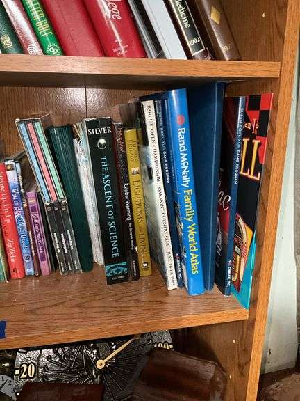 Book contents of four shelves: Bibles, golf, reference, misc