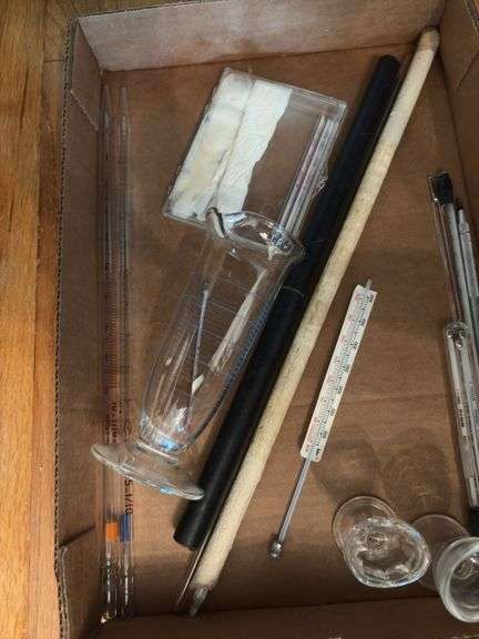 Glass eye wash cups, graduated beaker, thermometers