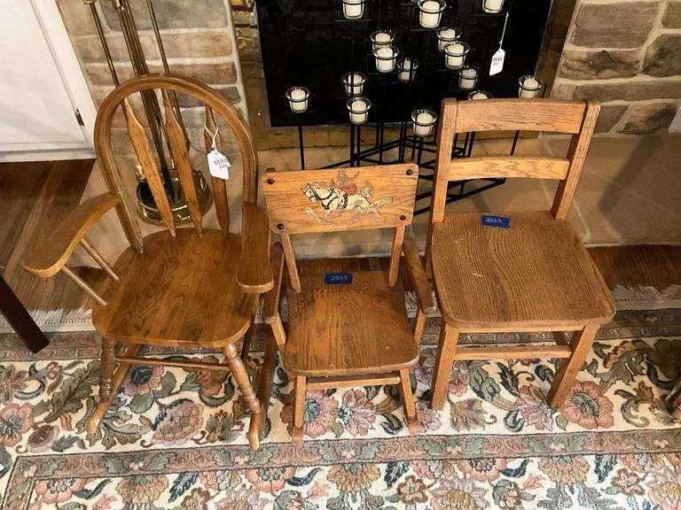 Three wooden child's chairs: two rockers, one side chair