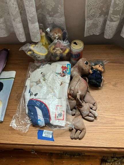 E.T. doll, Beauty and the Beast figures, troll doll, Mickey Mouse t-shirt, Billy beer can