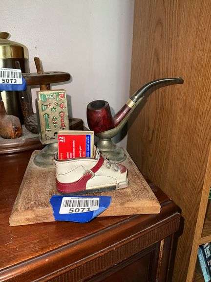 Smoking stand w/ pipe rest, matchbox holder and child's shoe, on wooden base