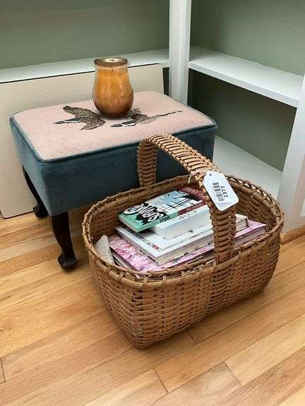 Foot stool w/ needlepoint and velvet upholstery, basket of books, jar candle