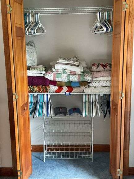 Contents of closet: afghans, linens, Phillies caps, wire shoe rack, hangers