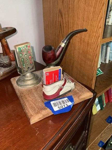 Smoking stand w/ pipe rest, matchbox holder and child's shoe, on wooden base