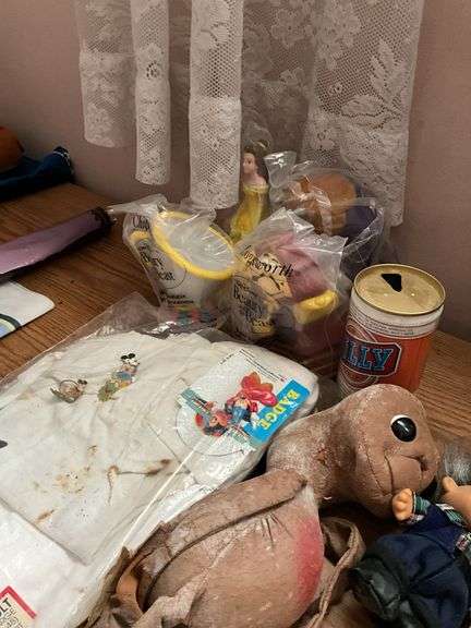 E.T. doll, Beauty and the Beast figures, troll doll, Mickey Mouse t-shirt, Billy beer can
