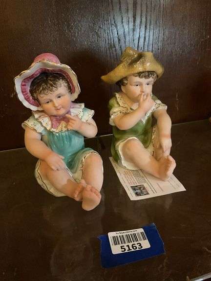 Two bisque piano baby figurines