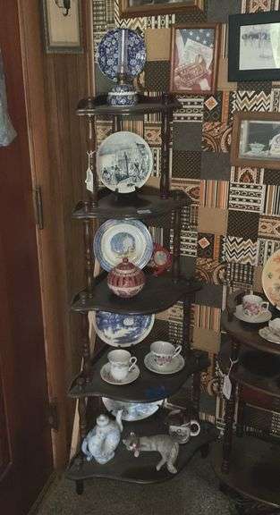 Contents of corner etagere: blue chintz oil lamp, collector plates, blue & white teapot, cups/saucers, cat figure, misc