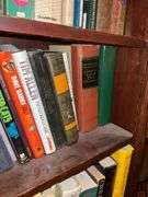 Book contents of three shelves: history, short stories, National Geographics, misc