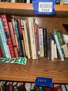 Book contents of four shelves: Bibles, golf, reference, misc