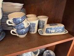 Contents of two shelves: Liberty Blue Historic Colonial Scenes dinnerware set w/ serving pcs