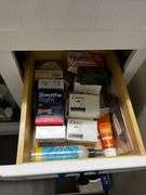 Stool, toilet stools, waste can, blood pressure monitor in box, contents of cabinet under sink and drawer